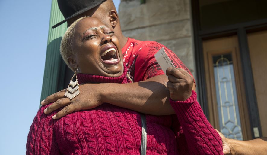 In this Sunday, Sept. 10, 2017, photo, Teresa Jenkins is comforted by her boyfriend on the porch of her apartment as she talks about her daughter, Kenneka Jenkins, in Chicago. Police investigating Jenkins' death, whose body was found inside a suburban Chicago hotel freezer, are examining a video that appears to show her in a room at the hotel hours earlier. (Alyssa Pointer/Chicago Tribune via AP)