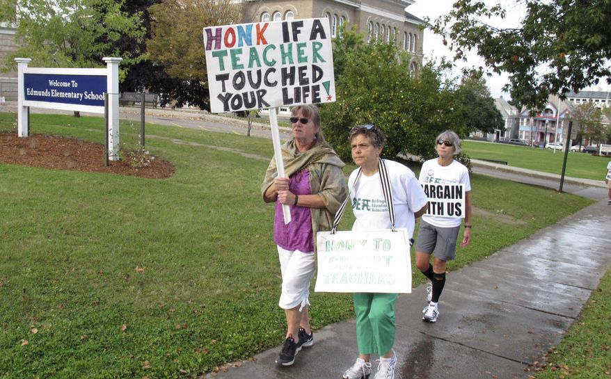Some of the about 400 teachers on strike in Burlington, Vt., walk the picket line in front of the Edmunds School on Thursday Sept. 14, 2017. Teachers say the main issue separating them from the board are working conditions. The school district counters the teachers brought up new demands at the final bargaining session. (AP Photo/Wilson Ring)