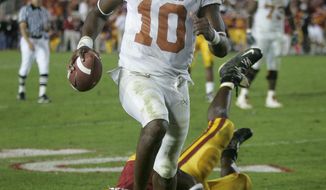 FILE - In this Jan. 4, 2006, file photo, Texas quarterback Vince Young rushes for the game-winning touchdown against Southern California during the Rose Bowl college football game in Pasadena, Calif. When Texas and Southern California last met on the football field, the Longhorns and Trojans put on a show many still call the greatest game in college football history. Texas (1-1) and No. 4 USC (2-0) meet again on Saturday night, Sept. 16, 2017. (AP Photo/Paul Sakuma, File)