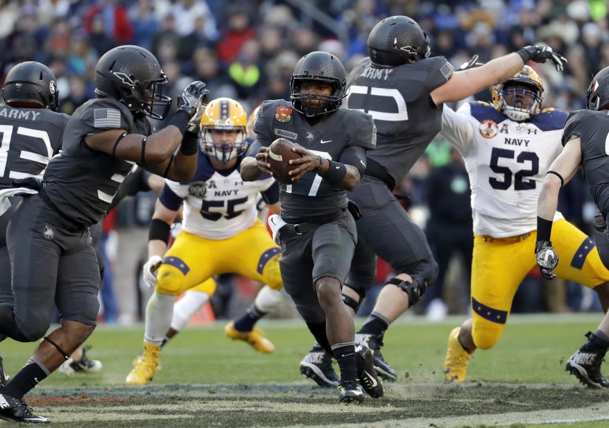 FILE - In this Dec. 10, 2016, file photo, Army quarterback Ahmad Bradshaw, center, drops back from the line of scrimmage in the first half against Navy in an NCAA college football game in Baltimore. Army, which plays at Ohio State this week, runs a confounding triple-option attack centered on Bradshaw, who is averaging 162 yards after two games to rank sixth nationally, and 9.5 yards per carry with three TDs. He has seven 100-yard games in his career. (AP Photo/Patrick Semansky, File)