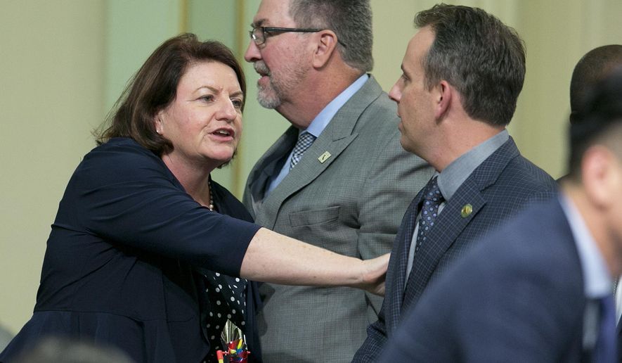 State Sen. Toni Atkins, D-San Diego, thanks Assemblyman Marc Levine, D-San Rafael, after he voted for her housing measure before the state Assembly, Thursday, Sept. 14, 2017, in Sacramento, Calif. Six bills aimed at addressing the crisis cleared the Assembly late Thursday after months of negotiations and cajoling. The bills all need Senate approval on Friday. (AP Photo/Rich Pedroncelli)