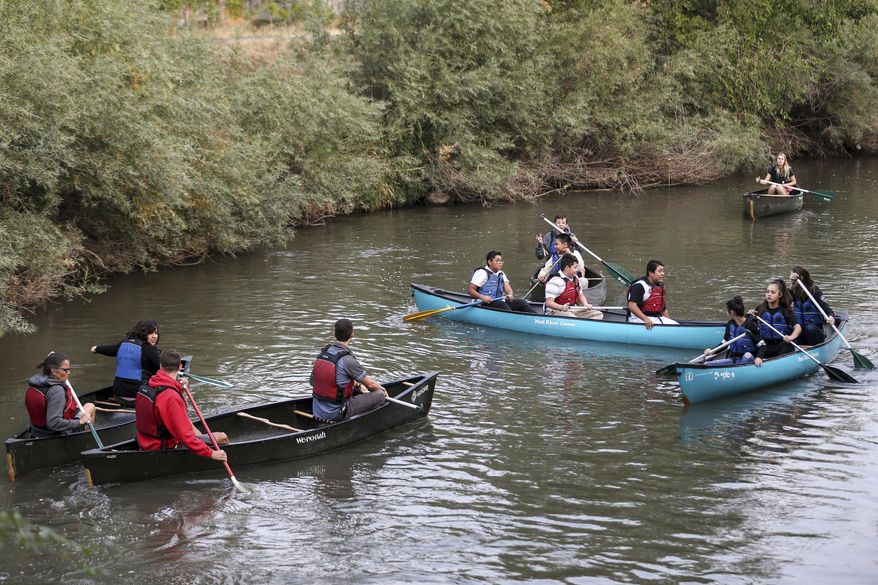 A group of students from Northwest Middle School and guides from Splore and the National Ability Center paddle canoes on the Jordan River in Salt Lake City on Thursday, Sept. 7, 2017. The canoeing trip was part of the Get Into the River Festival, a monthlong celebration featuring the Jordan River and the Jordan River Parkway. Throughout September, cities and counties along the river host events that help celebrate and raise awareness about the Jordan River. (Spenser Heaps/The Deseret News via AP)