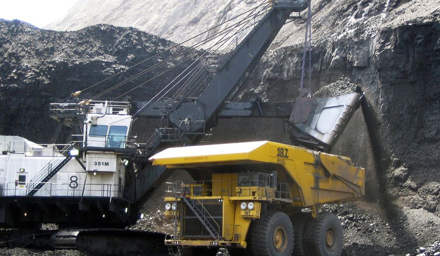 FILE - In this April 30, 2007, file photo, a shovel prepares to dump a load of coal into a 320-ton truck at the Arch Coal Inc.-owned Black Thunder mine in Wright, Wyo. A federal appeals court has sided with environmentalists trying to block mining at the two biggest coal mines in the U.S. on the grounds the coal contributes to climate change. (AP Photo/Matthew Brown, File)