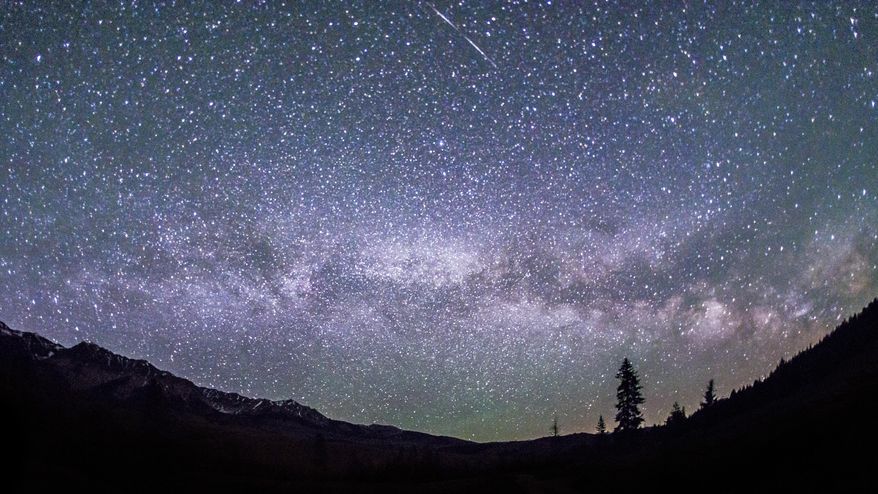 This June 4, 2016 photo provided by Nils Ribi Photography shows the Milky Way in the night sky at the foot of the Boulder Mountains in the Sawtooth National Recreation Area, Idaho. Tourists heading to central Idaho will be in the dark if local officials get their way. The nation's first International Dark Sky Reserve will fill a chuck of the sparsely populated region containing night skies so pristine that interstellar dust clouds are visible in the Milky Way. The International Dark Sky Association says the region is one of the few places remaining in the contiguous United States large enough and dark enough to attain reserve status. Nearby towns, county and federal officials and a conservation group are working with the association to submit an application this month to designate 1,400 square miles (3,600 square kilometers) as the reserve that could draw visitors. (Nils Ribi Photography via AP)