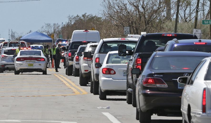 Motorists line up to enter the Florida Keys at a checkpoint in the aftermath of Hurricane Irma, Thursday, Sept. 14, 2017, in Florida City, Fla. Residents of the Florida Keys continue to be turned away. (AP Photo/Alan Diaz)