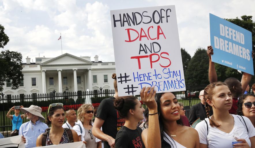In this Sept. 5, 2017, file photo, Yurexi Quinones, 24, of Manassas, Va., a college student who is studying social work and a recipient of Deferred Action for Childhood Arrivals, known as DACA, rallies next to Ana Rice, 18, of Manassas, Va., far right, in support of DACA, outside of the White House in Washington. (AP Photo/Jacquelyn Martin, File)