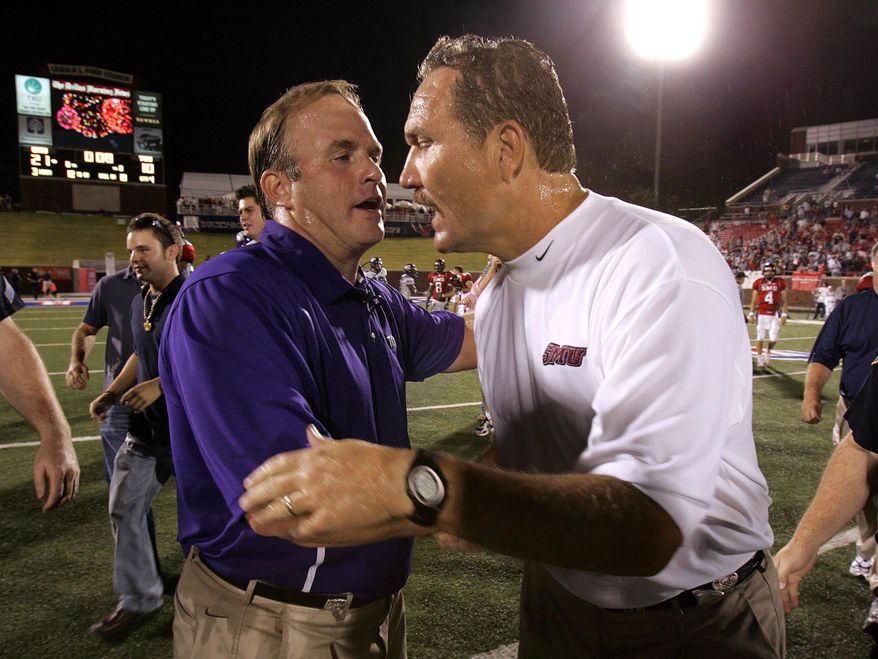 FILE - In this Sept. 10, 2005, file photo, TCU head coach Gary Patterson, left, congratulates SMU head coach Phil Bennett, right, after SMU upset TCU 21-10 in an NCAA college football game in Dallas. Patterson has again told his team about 2005, when the Horned Frogs’ only loss was to SMU. That is the coach’s annual reminder about that loss to the Mustangs right after a season-opening win at seventh-ranked Oklahoma. The two schools meet on Saturday. (AP Photo/LM Otero, File)