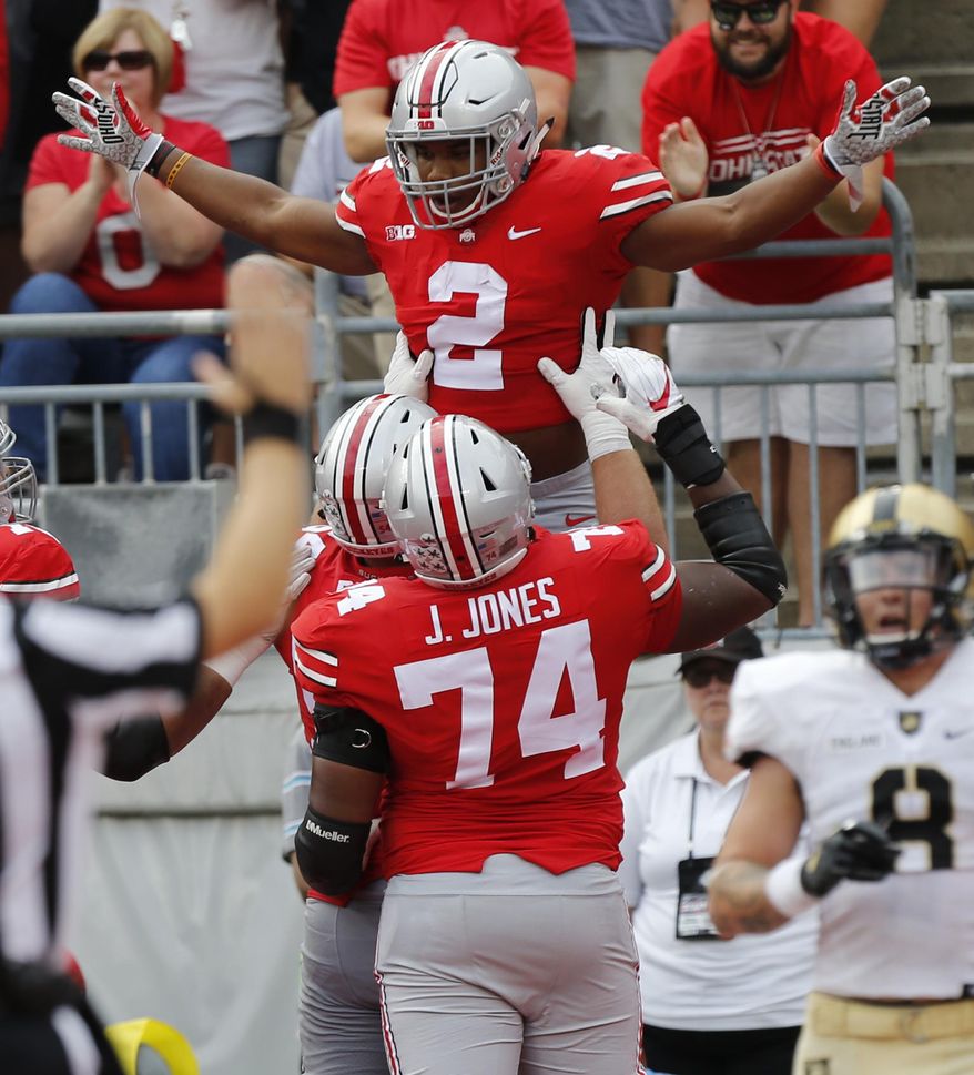 Ohio State running back J.K. Dobbins, top, celebrates his touchdown against Army during the first half of an NCAA college football game Saturday, Sept. 16, 2017, in Columbus, Ohio. (AP Photo/Jay LaPrete)