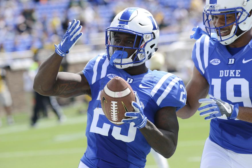 Duke's Brittain Brown (22) celebrates his touchdown with Quay Chambers during an NCAA college football game against Baylor, Saturday , Sept. 16, 2017, in Durham, N.C. (Bernard Thomas/The Herald-Sun via AP)