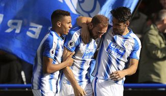 Huddersfield Town&#39;s Laurent Depoitre, centre,  celebrates with his team-mates after scoring his side&#39;s first goal, during the English Premier League soccer match between Huddersfield and Leicester City, at the John Smith&#39;s Stadium, in Huddersfield, England, Saturday, Sept. 16, 2017. (Mike Egerton/PA via AP)