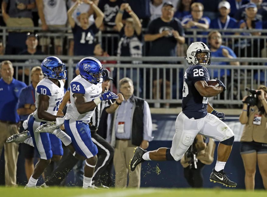 Penn State's Saquon Barkley (26) runs in for a touchdown after a catch against Georgia State during the first half of an NCAA college football game in State College, Pa., Saturday, Sept. 16, 2017. (AP Photo/Chris Knight)
