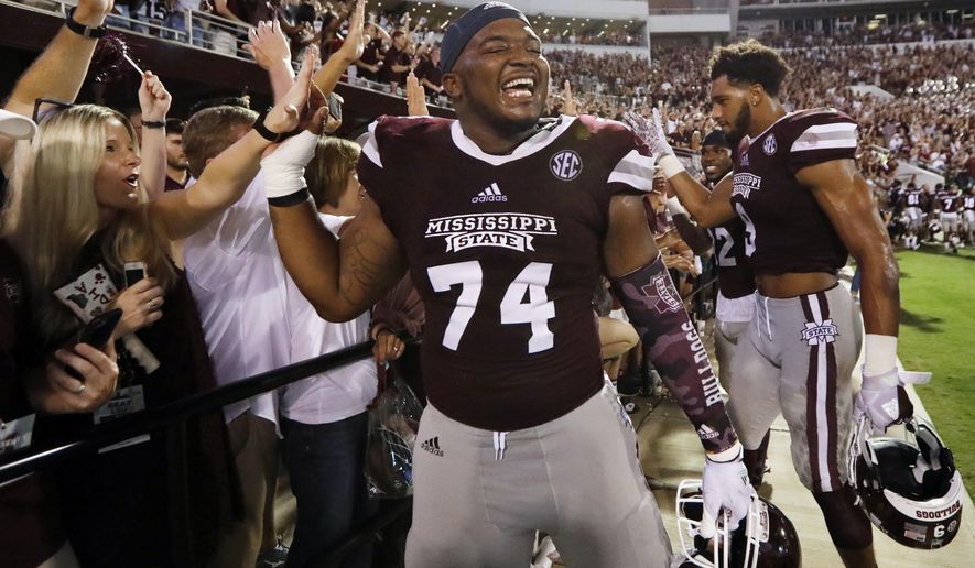 Mississippi State offensive lineman Elgton Jenkins (74) is congratulated by fans following their NCAA college football game win against LSU in Starkville, Miss., Saturday, Sept. 16, 2017. Mississippi State won 37-7. (AP Photo/Rogelio V. Solis)