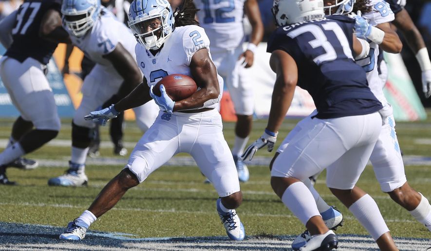 UNC's Jordan Brown (2) finds a seam past Old Dominion's Sean Carter (31) during the first half of an NCAA college football game, Saturday, Sept. 16, 2017 in Norfolk, Va. (AP Photo/Jason Hirschfeld)