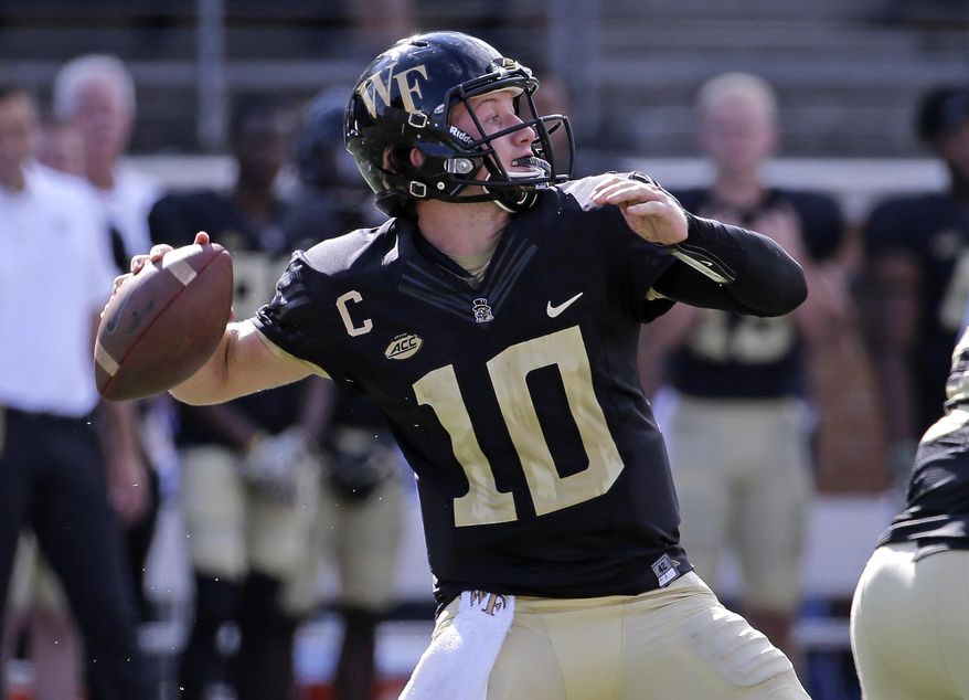 Wake Forest's John Wolford (10) looks to pass against Utah State in the first half of an NCAA college football game in Winston-Salem, N.C., Saturday, Sept. 16, 2017. (AP Photo/Chuck Burton)