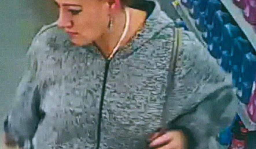 An undated security video image released by The Spokane County Sheriff's Office shows a person of interest in the theft of a purse of a parent who rushed to check on her child following the school shooting at Freeman High School in Rockford, Wash. Authorities say the purse was stolen Wednesday, Sept. 13, 2017, as parents converged on Freeman High School, where a gunman had opened fire, killing one student and injuring three others. (Spokane County Sheriff's Office via AP)