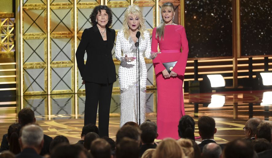 Lily Tomlin, from left, Dolly Parton, Jane Fonda speak at the 69th Primetime Emmy Awards on Sunday, Sept. 17, 2017, at the Microsoft Theater in Los Angeles. (Photo by Phil McCarten/Invision for the Television Academy/AP Images)