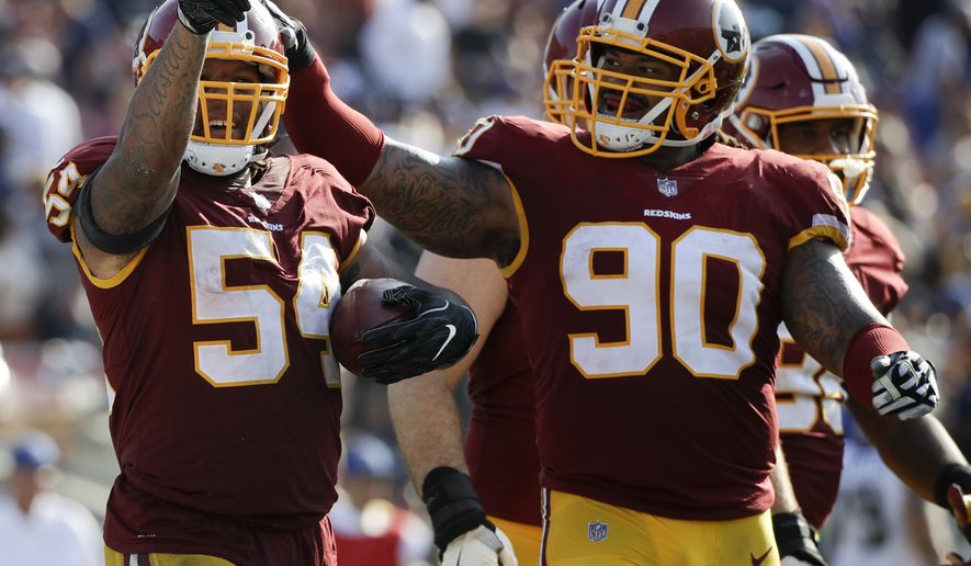 Washington Redskins inside linebacker Mason Foster, left, celebrates after intercepting a pass woth Ziggy Hood during the second half of an NFL football game against the Los Angeles Rams Sunday, Sept. 17, 2017, in Los Angeles. (AP Photo/Jae C. Hong)
