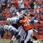 Dallas Cowboys running back Ezekiel Elliott (21) is hit by Denver Broncos outside linebacker Shaquil Barrett (48) during the first half of an NFL football game, Sunday, Sept. 17, 2017, in Denver. (AP Photo/Jack Dempsey)