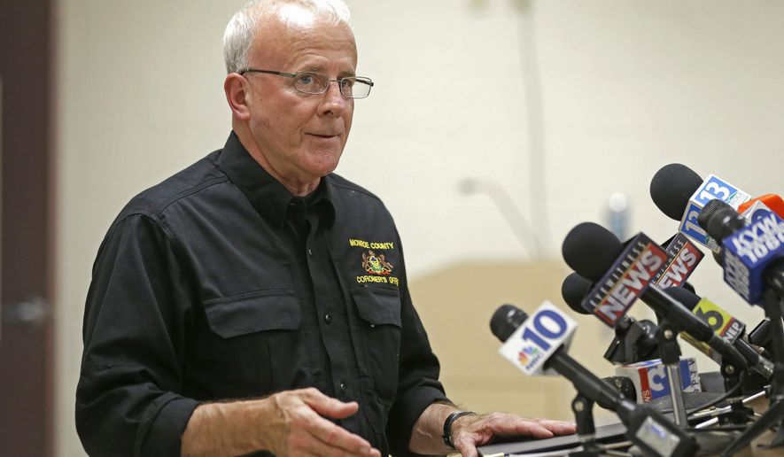 FILE – In this Aug. 6, 2013, file photo, Monroe County Coroner Bob Allen discusses charges against a man who eventually pleaded guilty to killing multiple people at a municipal meeting in the Poconos, during a news conference in Stroudsburg, Pa. Lurid claims about the Monroe County coroner's office under Allen's leadership have ignited a sex scandal in Pennsylvania's Pocono Mountains, prompting a police investigation of allegations that include sex at a death scene and stealing prescription drugs from the deceased. (AP Photo/Matt Rourke, File)