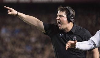 South Carolina head coach Will Muschamp communicates with players during the first half of an NCAA college football game against Kentucky, Saturday, Sept. 16, 2017, in Columbia, S.C. (AP Photo/Sean Rayford)