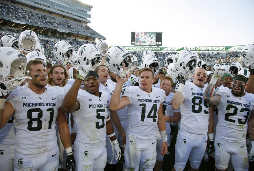 FILE - ADVANCE FOR USE SUNDAY, SEPT. 17 - In this Saturday, Sept. 9, 2017, file photo, Michigan State players, including Matt Sokol (81), Andrew Dowell (5), Brian Lewerke (14), Matt Dotson (89) and Chris Frey (23), celebrate following a 28-14 win over Western Michigan in an NCAA college football game in East Lansing, Mich. Michigan State knows better than to get too carried away after a 2-0 start. The Spartans won their first two games last season but finished 3-9. (AP Photo/Al Goldis)