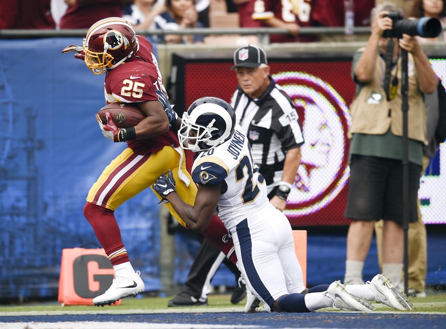 Washington Redskins running back Chris Thompson, left, scores past Los Angeles Rams free safety Lamarcus Joyner during the first half of an NFL football game Sunday, Sept. 17, 2017, in Los Angeles. (AP Photo/Kelvin Kuo)
