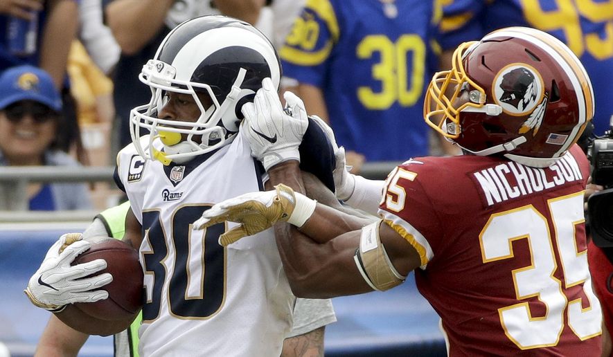 Los Angeles Rams running back Todd Gurley, left, is tackled by Washington Redskins safety Montae Nicholson during the first half of an NFL football game Sunday, Sept. 17, 2017, in Los Angeles. (AP Photo/Jae C. Hong) **FILE**