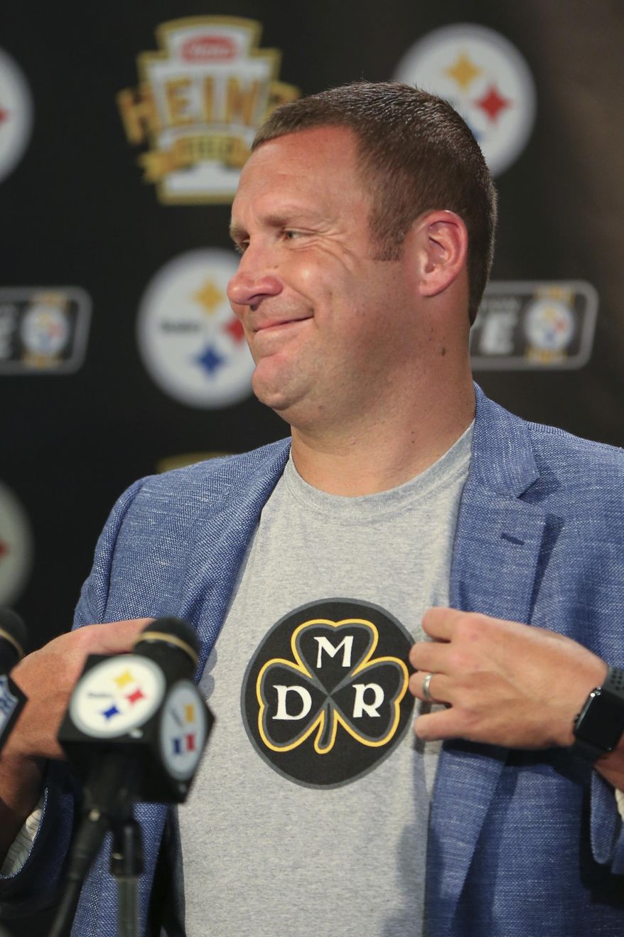 Pittsburgh Steelers quarterback Ben Roethlisberger smiles as he shows his shirt meant to honor the late president of the team, Dan Rooney, who died earlier this year, during a news conference after an NFL football game against the Minnesota Vikings, Sunday, Sept. 17, 2017, in Pittsburgh. (AP Photo/Keith Srakocic)