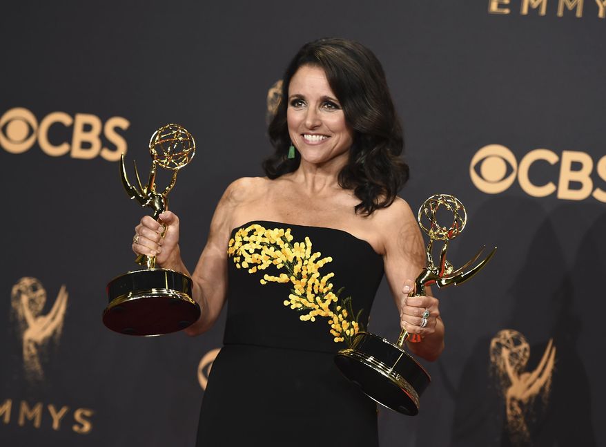 Julia Louis-Dreyfus poses in the press room with her awards for outstanding lead actress in a comedy series and outstanding comedy series for "Veep" at the 69th Primetime Emmy Awards on Sunday, Sept. 17, 2017, at the Microsoft Theater in Los Angeles. (Photo by Jordan Strauss/Invision/AP)