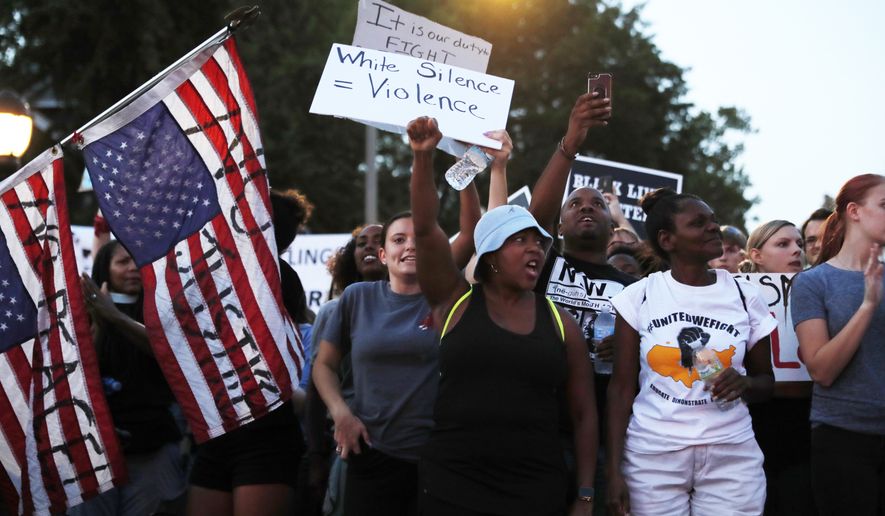Demonstrators march in response to a not guilty verdict in the trial of former St. Louis police officer Jason Stockley Saturday, Sept. 16, 2017, in St. Louis. Stockley was acquitted in the 2011 killing of a black man following a high-speed chase. (AP Photo/Jeff Roberson)