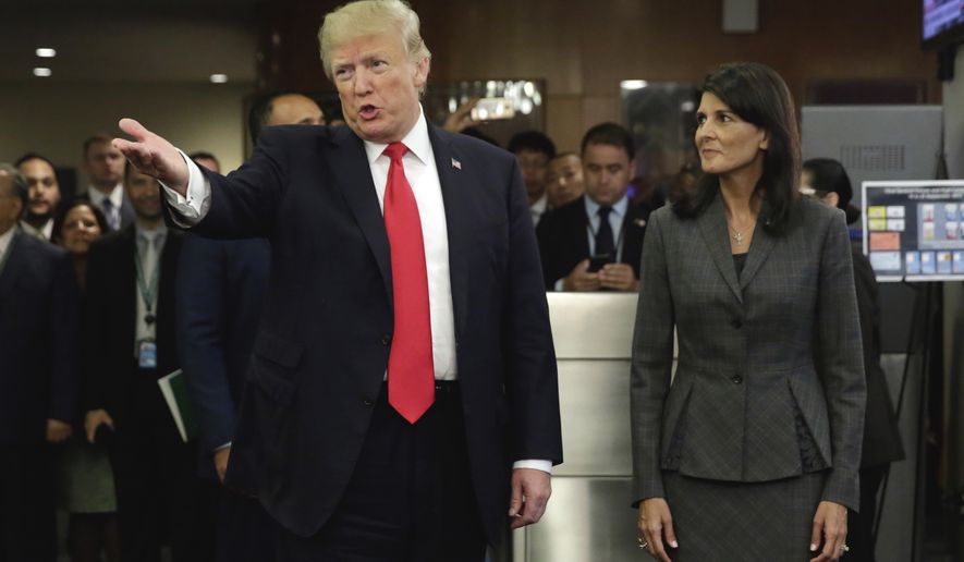 President Donald Trump, accompanied by U.S. Ambassador Nikki Haley, arrives at the United Nations, Monday, Sept. 18, 2017. (AP Photo/Richard Drew)