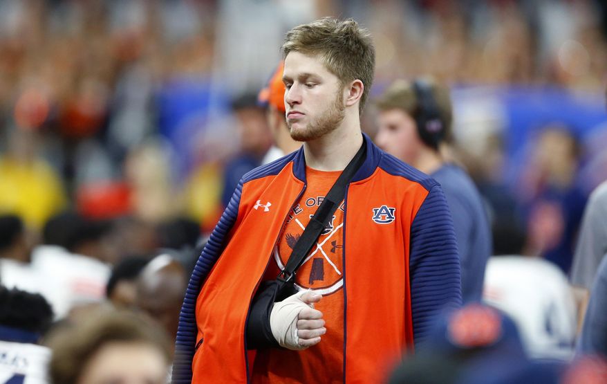 FILE - In this Jan. 2, 2017, file photo, Auburn quarterback Sean White walks on the sideline with his arm in a cast and sling in the second half of the Sugar Bowl NCAA college football game against Oklahoma in New Orleans. Auburn backup quarterback Sean White has been arrested on a charge of public intoxication. Jail records show that the 21-year-old White was taken to the Lee County Detention Center at 3:28 a.m. Sunday, Sept. 17, 2017. (AP Photo/Butch Dill, File)