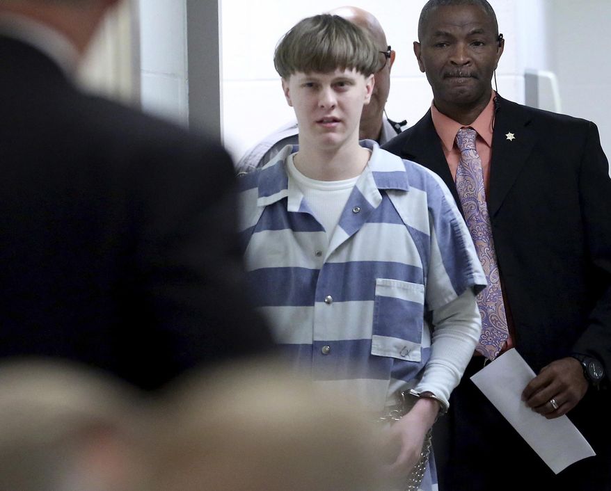 FILE - In this Monday, April 10, 2017, file photo, Dylann Roof enters the court room at the Charleston County Judicial Center to enter his guilty plea on murder charges in Charleston, S.C. Roof, a white supremacist who was sentenced to death in the 2015 massacre of nine black worshippers, has told a federal appeals court he wants to fire his appellate attorneys because one of them is Jewish and the other is Indian. In a handwritten request filed Monday, Sept. 18, with the 4th U.S. Circuit Court of Appeals in Richmond, Va., Roof wrote that his attorneys' backgrounds are "a barrier to effective communication." (Grace Beahm/The Post And Courier via AP, Pool, File)