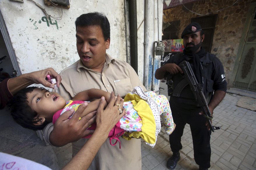 A health worker gives a polio vaccine to a child in Peshawar, Pakistan, Monday, Sept. 18, 2017, Polio remains endemic in Pakistan after the Taliban banned vaccinations, instigated attacks targeting medical staffers and spread suspicions about the vaccine. (Muhammad Sajjad)