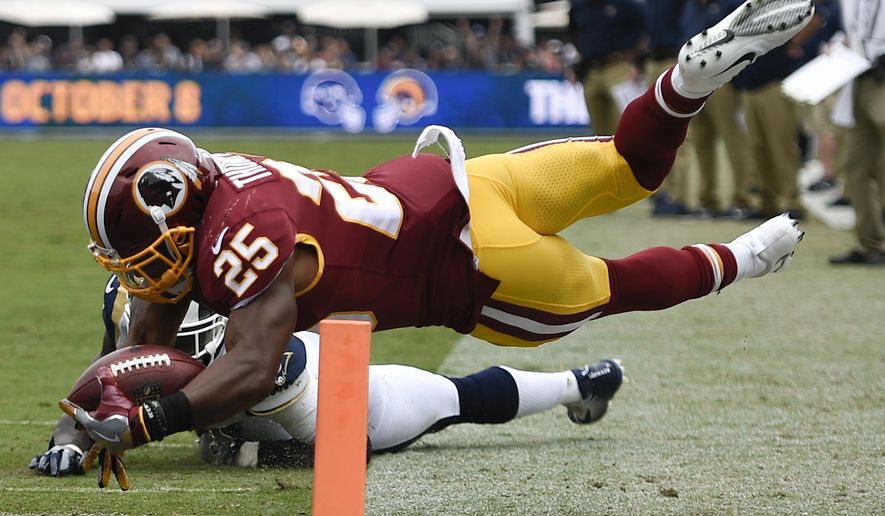 Washington Redskins running back Chris Thompson scores past Los Angeles Rams strong safety Maurice Alexander during the first half of an NFL football game Sunday, Sept. 17, 2017, in Los Angeles. (AP Photo/Kelvin Kuo)