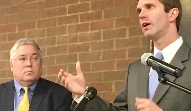 Kentucky Attorney General Andy Beshear (right) speaks about opioid addiction at a news conference Monday, Sept. 18, 2017 at Marshall University in Huntington, West Virginia. At left is West Virginia Attorney General Patrick Morrisey. (AP Photo/John Raby)