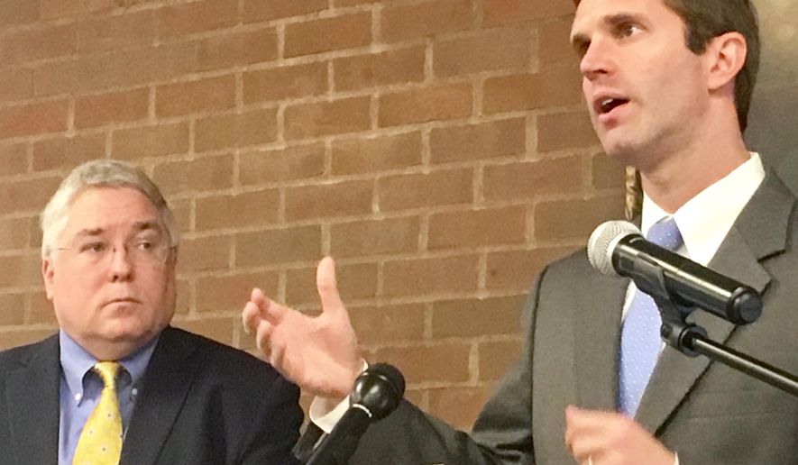 Kentucky Attorney General Andy Beshear (right) speaks about opioid addiction at a news conference Monday, Sept. 18, 2017 at Marshall University in Huntington, West Virginia. At left is West Virginia Attorney General Patrick Morrisey. (AP Photo/John Raby)