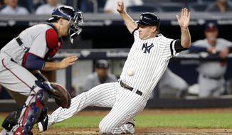 Minnesota Twins catcher Jason Castro waits for the throw as New York Yankees designated hitter Chase Headley scores on Todd Frazier&#39;s sixth-inning sacrifice fly in a baseball game in New York, Monday, Sept. 18, 2017. (AP Photo/Kathy Willens)