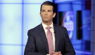 Donald Trump Jr. is interviewed by host Sean Hannity on the Fox News Channel television program, in New York. (AP Photo/Richard Drew, File)
