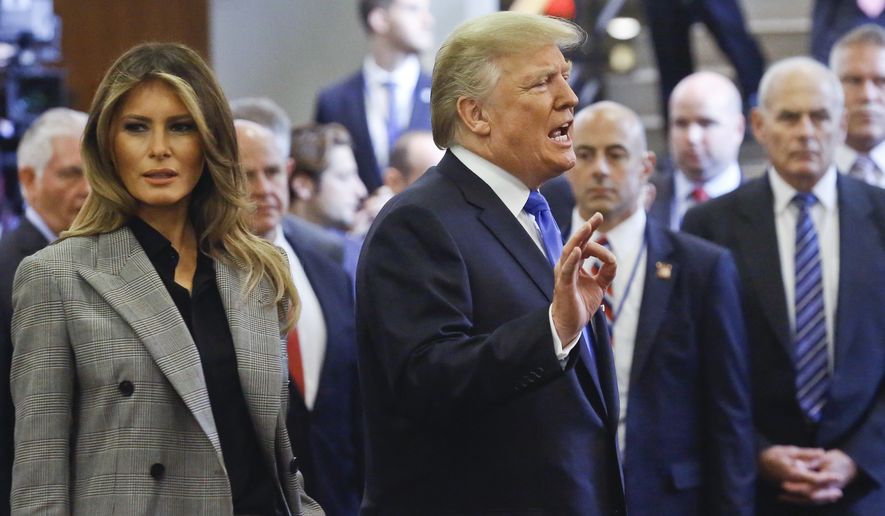 U.S. President Donald Trump, center, with first lady Melania Trump, left, speaks to media as he leaves following his address to the United Nations General Assembly, Tuesday Sept. 19, 2017 at U.N. headquarters. (AP Photo/Bebeto Matthews)