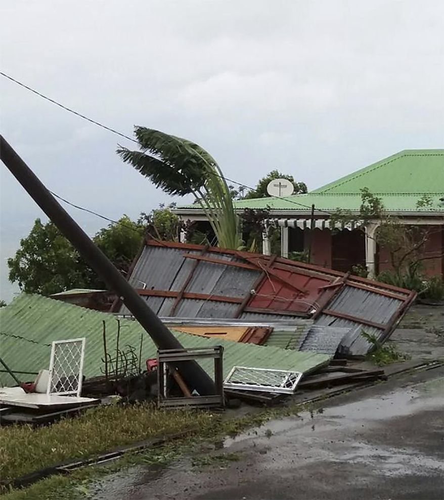 This photo provided by Jenny Promeneur shows storm damage to her grandmother's tool shed/dog house, caused by Hurricane Maria in Bouillante, Guadeloupe, Tuesday, Sept. 19, 2017. (Jenny Promeneur via AP)