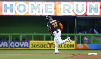 FILE - In this Sept. 2, 2017, file photo, Miami Marlins&#39; Giancarlo Stanton rounds second base after hitting a home run during the first inning of a baseball game against the Philadelphia Phillies, in Miami. Nearly two decades after the height of the Steroids Era, Major League Baseball is on track to break its season record for home runs on Tuesday with nearly two weeks left in the season. There were 5,663 home runs hit through Sunday, 30 shy of the record 5,693 set in 2000. (AP Photo/Wilfredo Lee, File)