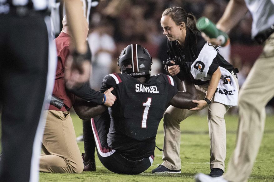 FILE - In this Saturday, Sept. 16, 2017, file photo, South Carolina wide receiver Deebo Samuel (1) is helped by trainers after an injury during the second half of an NCAA college football game against Kentucky in Columbia, S.C. South Carolina has 11 touchdowns its first three games, six of them by Samuel. Now, with Samuel sidelined with a left leg fracture, the Gamecocks need to find other players capable of stepping up and filling in for the dyanmic Samuel(AP Photo/Sean Rayford, File)