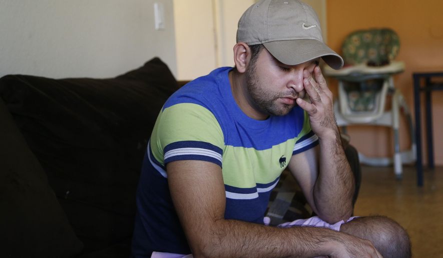 Cesar Garcia wipes his eye as he talks about how he and other family members survived the Payson, Ariz., flash flooding this summer that killed 10 other family members, at his home, Wednesday, Sept. 20, 2017, in Phoenix. (AP Photo/Ross D. Franklin)