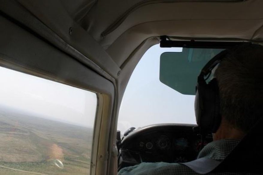 In this Sept. 6, 2017 photo, Bruce Gordon pilots a six-seat plane as local leaders observe the impact of oil and gas developments on Eddy County, N.M. wilderness.  (Adrian Hedden/Carlsbad Current Argus via AP)