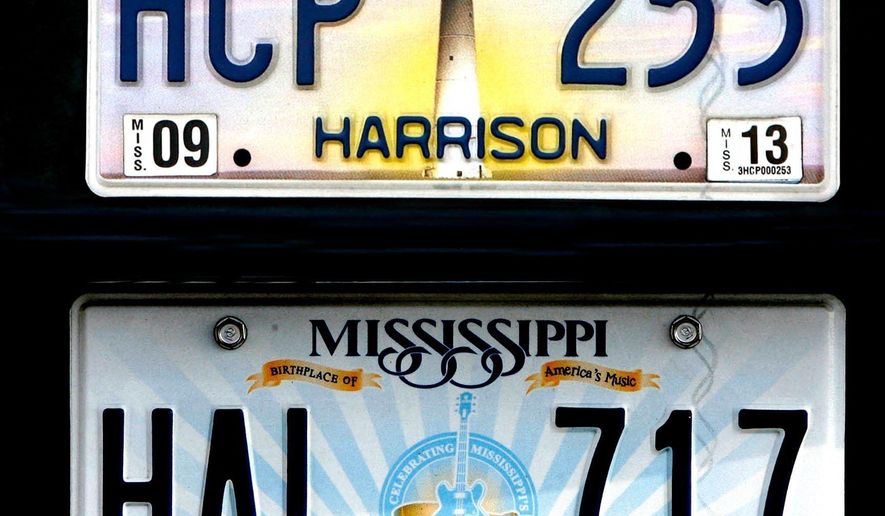 This undated photo shows the Biloxi Lighthouse plate, top, and the plate that replaced it which pictures blues legend BB King's guitar "Lucille" and the phrase "Birthplace of America's Music" in Mississippi. The license plate with the guitar will remain unchanged because the state legislature didn't allocate funds to replace them. (Tim Isbell/The Sun Herald via AP)