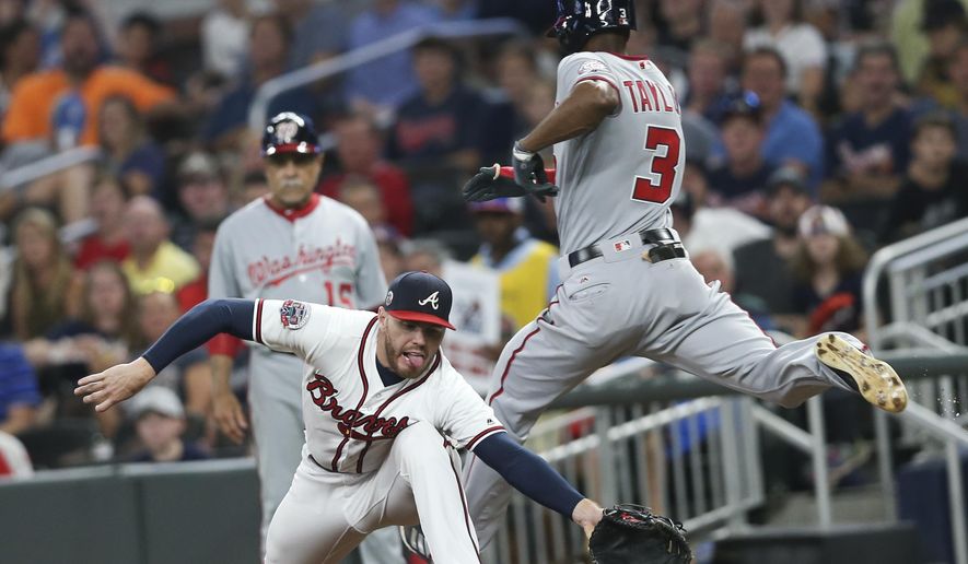 Washington Nationals&#x27; Michael Taylor (3) beats out a ground ball for a single as Atlanta Braves first baseman Freddie Freeman (5) reaches for the ball in the fifth inning of a baseball game Wednesday, Sept. 20, 2017, in Atlanta. (AP Photo/John Bazemore) **File**
