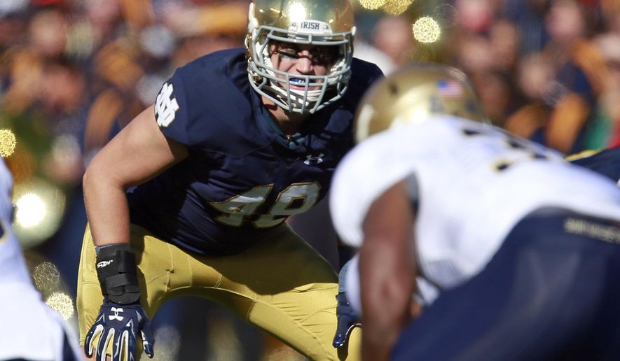 FILE - In this Oct. 10, 2015, file photo, Notre Dame linebacker Greer Martini (48) lines up against Navy during the first half of an NCAA college football game in South Bend, Ind. Martini's not necessarily an Irish star, but he has started multiple games all four of his seasons, was chosen as a captain this year and is viewed as particularly reliable against the run as ND gets set to visit 2-0 Michigan State. (AP Photo/Jeff Haynes, File)