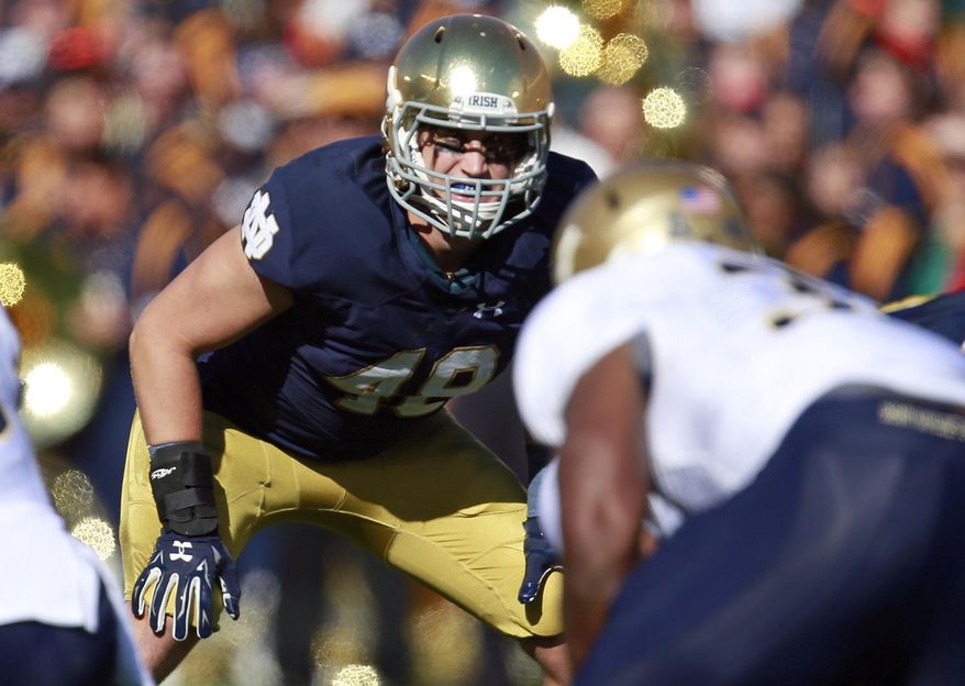FILE - In this Oct. 10, 2015, file photo, Notre Dame linebacker Greer Martini (48) lines up against Navy during the first half of an NCAA college football game in South Bend, Ind. Martini's not necessarily an Irish star, but he has started multiple games all four of his seasons, was chosen as a captain this year and is viewed as particularly reliable against the run as ND gets set to visit 2-0 Michigan State. (AP Photo/Jeff Haynes, File)