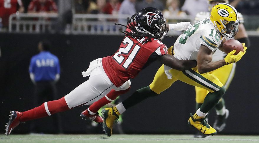 FILE - In this Sunday, Sept. 17, 2017 file photo, Green Bay Packers wide receiver Randall Cobb (18) makes the catch against Atlanta Falcons cornerback Desmond Trufant (21) during the first of an NFL football game in Atlanta. The banged-up Green Bay Packers are starting practice this week with about a dozen players on the injury report. Receivers Jordy Nelson and Randall Cobb, along with defensive lineman Mike Daniels were among the notable Packers who left last week’s 34-23 loss to Atlanta with injuries. Coach Mike McCarthy spoke broadly about the injuries before practice on Wednesday, Sept. 20, 2017. (AP Photo/David Goldman, File)